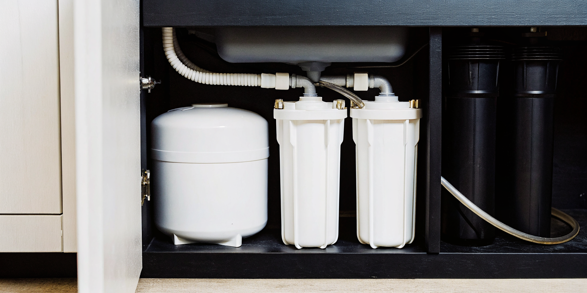 Professional multi-stage reverse osmosis water filtration system installed under a kitchen sink